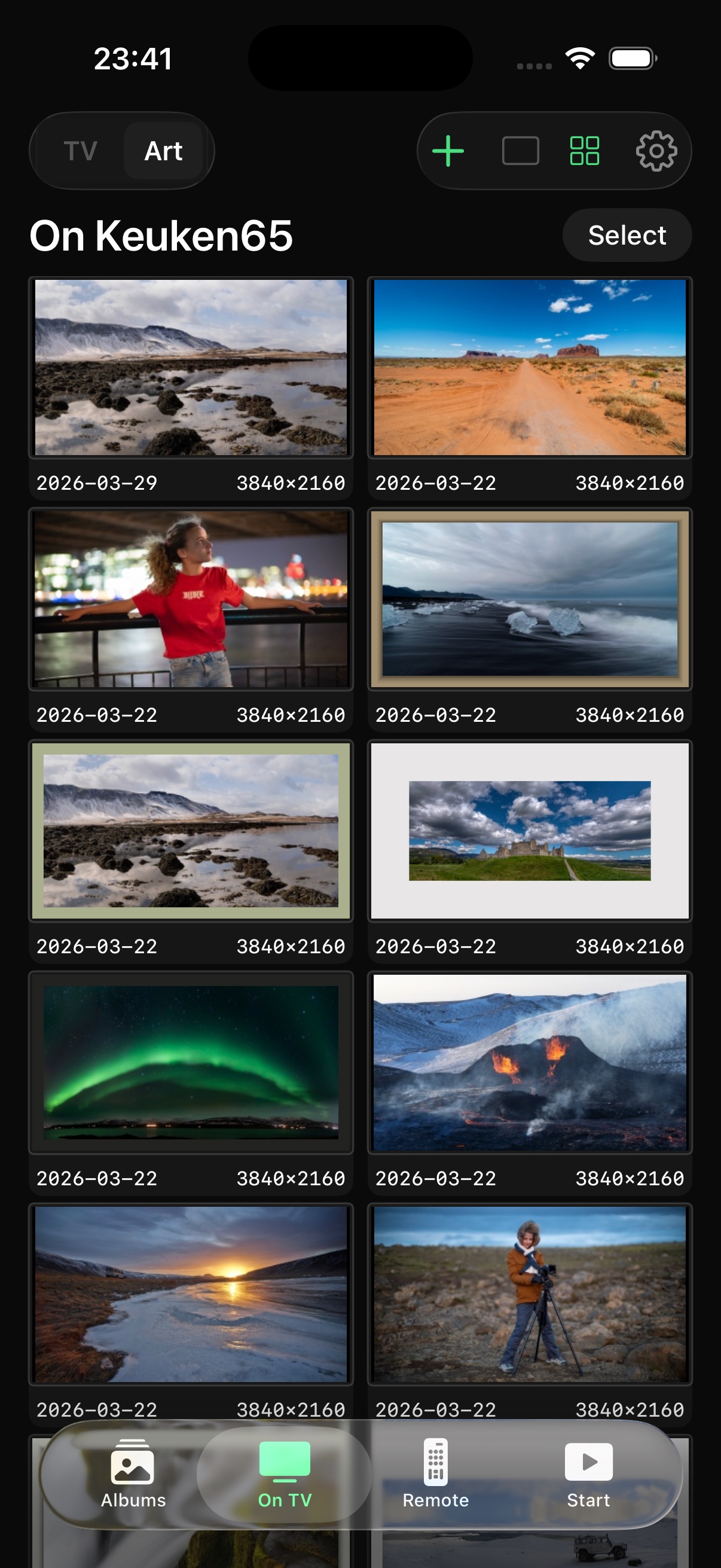 FrameSync app showing photos being uploaded to a Samsung Frame TV on the wall