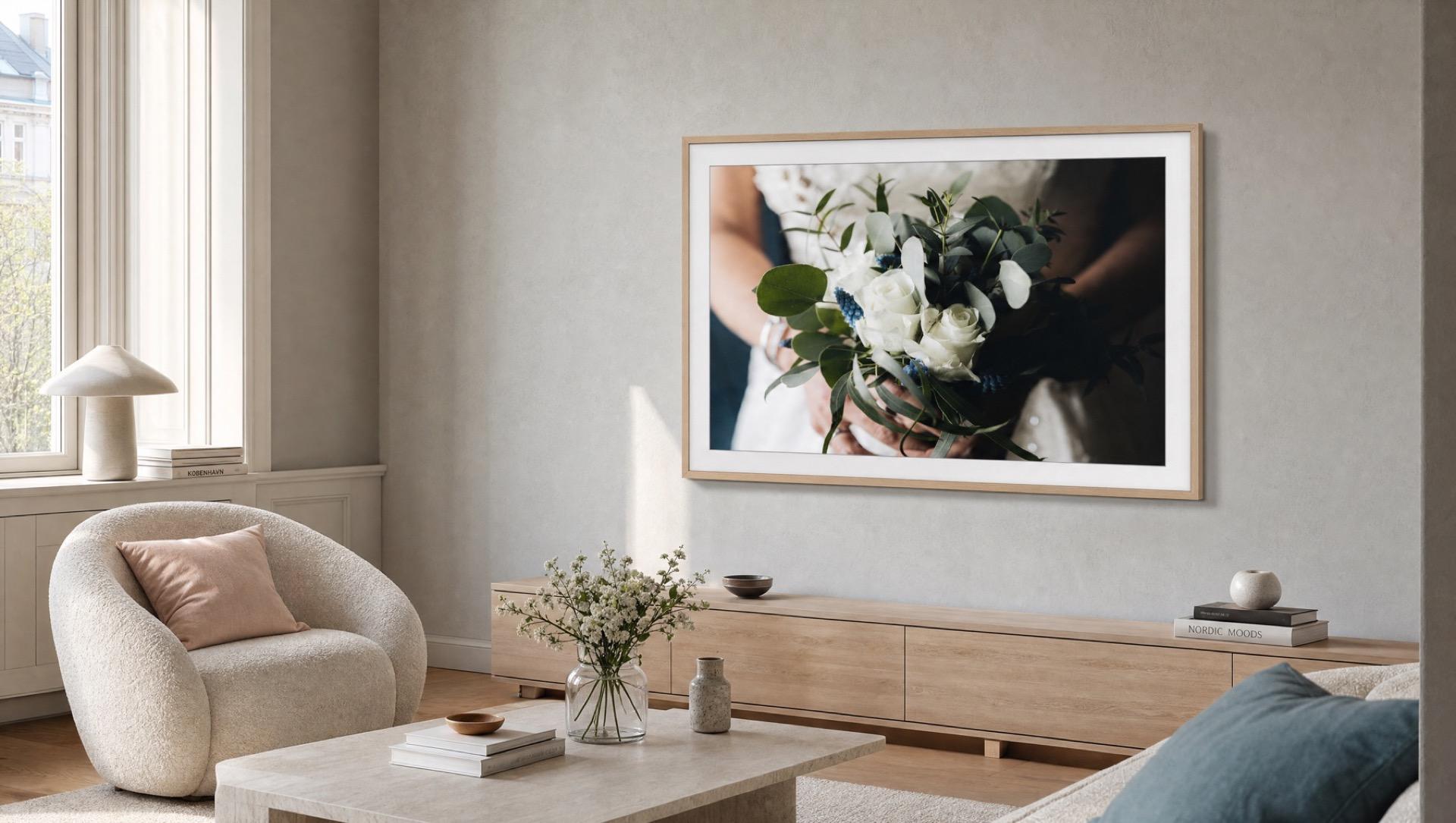 A client’s bridal bouquet photograph displayed on a Samsung The Frame TV on a gallery-clean white wall
